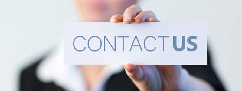 A picture of a person holding a card that states, Contact Us